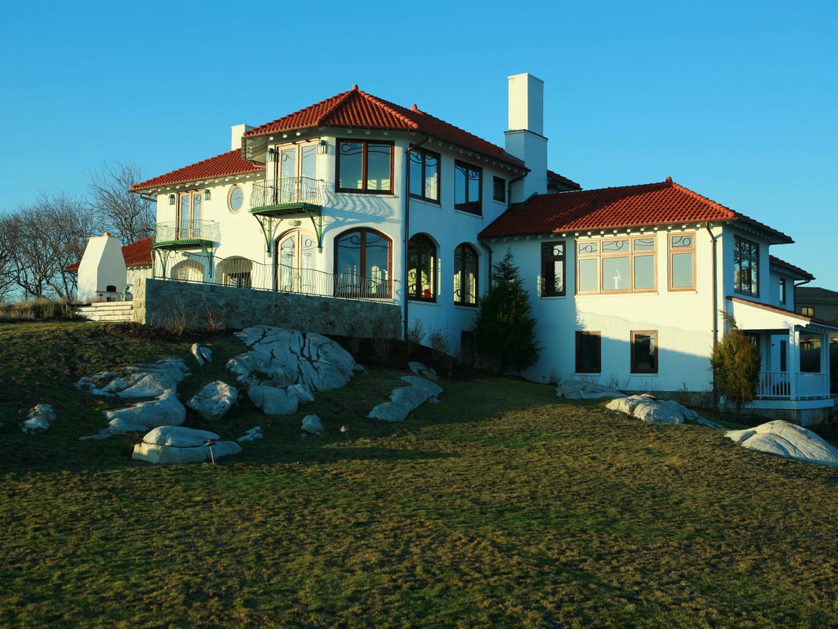A Mediterranean-style oceanfront estate with custom ironwork balconies and arched windows